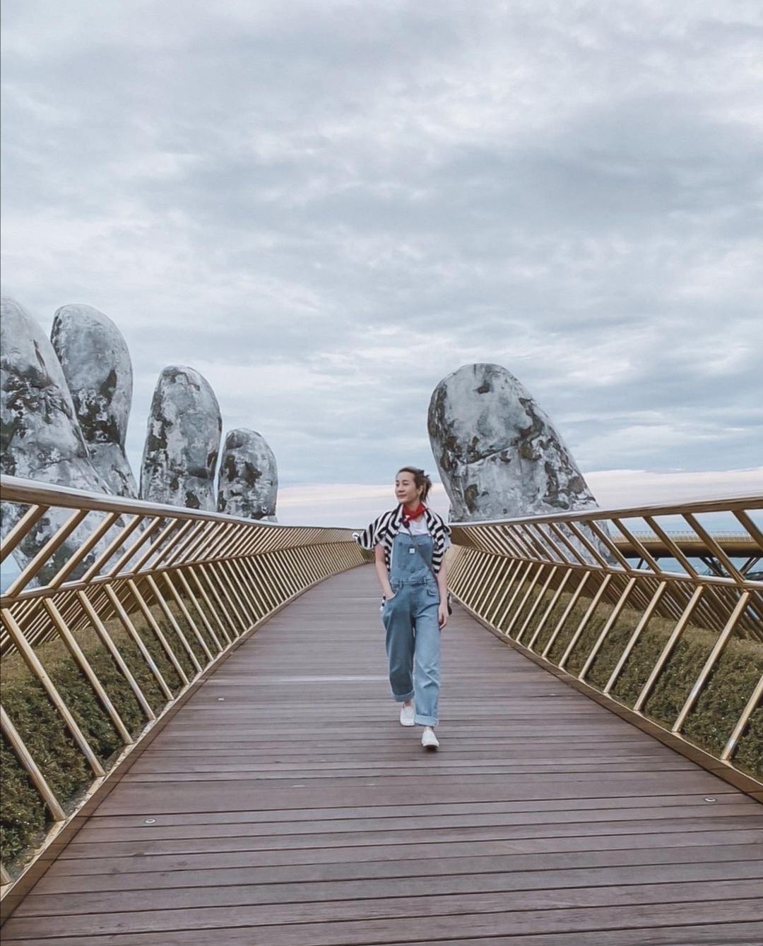 A visitor walking on the golden bridge